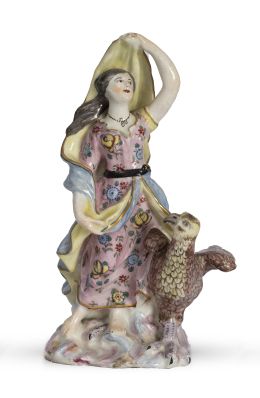 1196.  Figura escultórica femenina con ave de porcelana esmaltada.Posiblemente Inglaterra, h. 1800.