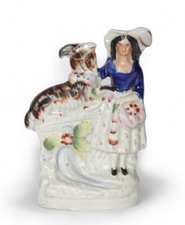 717.  Figura femenina con cabra.Figura de loza esmaltada.Staffordshire, Inglaterra, ff. del S. XIX.