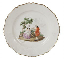 730.  Plato en porcelana esmaltada y dorada decorada con escena galante en un pasaisaje. Con marca en azul cobalto.Buen Retiro, (1760-1784).