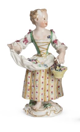 1285.  Niña con cesto de flores. Con marcas en la base.Figura escultórica de porcelana esmaltadaS. XIX.