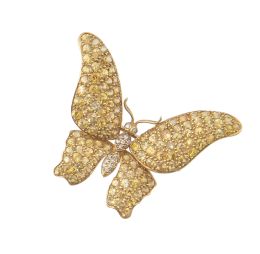 238.  Broche mariposa con alas cuajadas de zafiros amarillos y cu