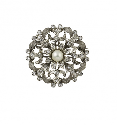 Broche circular de brillantes con formas vegetales y flor c